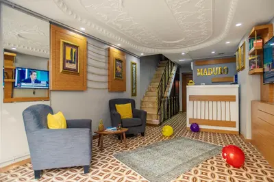 a living room with two chairs and a crib at Maduro Hotel Istanbul in Istanbul