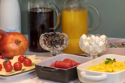 a table with plates of food and glasses of juice at Nika otel & cafe in Istanbul