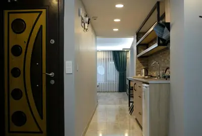a kitchen with a door leading into a kitchen with a counter at Sare House in Istanbul