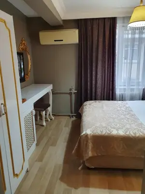 a bedroom with a bed and a desk and a window at Şehir Hotel Old City in Istanbul