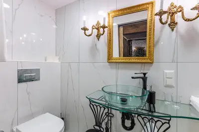 a bathroom with a glass sink and a mirror at Villa Pera Suite Hotel in Istanbul