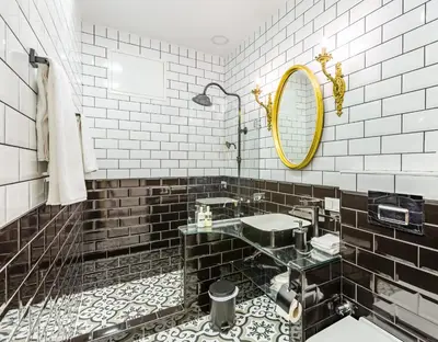a black and white bathroom with a sink and a mirror at Villa Pera Suite Hotel in Istanbul