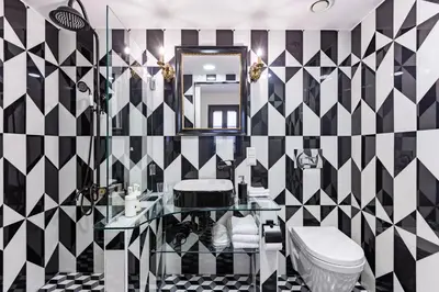 a bathroom with a black and white checkered wall at Villa Pera Suite Hotel in Istanbul