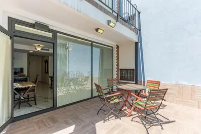 a patio with chairs and a table on a balcony at Villa Pera Suite Hotel in Istanbul