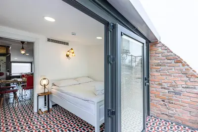 a bedroom with a bed and a brick wall at Villa Pera Suite Hotel in Istanbul