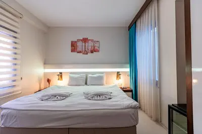 a bedroom with a large white bed with two pillows at Stanpoli Hostel in Istanbul