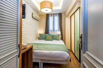 a small bedroom with a bed and a window at Interstar Hotel - Sultanahmet in Istanbul