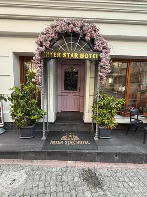 a hotel entrance with a pink door and flowers at Interstar Hotel - Sultanahmet in Istanbul
