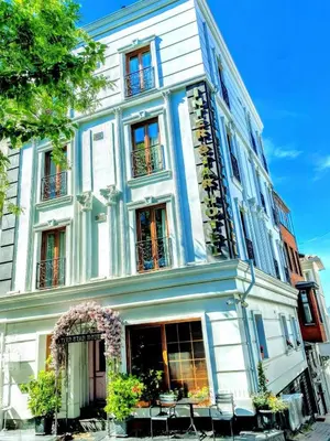 a white building with chairs in front of it at Interstar Hotel - Sultanahmet in Istanbul