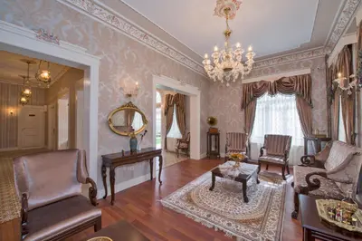 a living room with a chandelier and a table and chairs at Enderun Hotel Istanbul in Istanbul