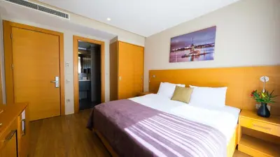 a hotel room with a large bed and a desk at Endless Suites Taksim in Istanbul