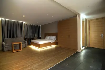 a bedroom with a bed and a couch and a chair at Endless Suites Taksim in Istanbul