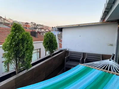a hammock on the balcony of a building at Elele Aparts in Istanbul