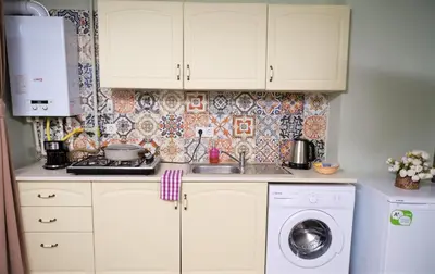 a kitchen with white cabinets and a washing machine at Elele Aparts in Istanbul