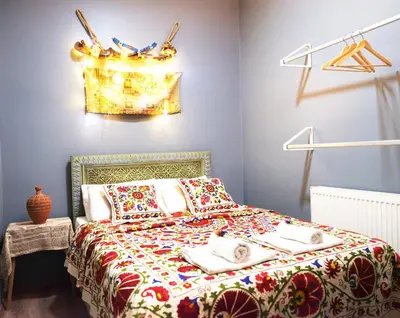 a bedroom with a bed with a colorful bedspread at Elele Aparts in Istanbul
