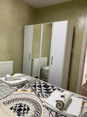 a bedroom with a bed and a large mirror at Elele Aparts in Istanbul