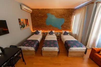 a room with four beds and a brick wall at ROYAL TAKSIM SUITES in Istanbul