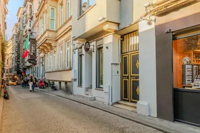 a street with buildings and people walking down the street at ROYAL TAKSIM SUITES in Istanbul