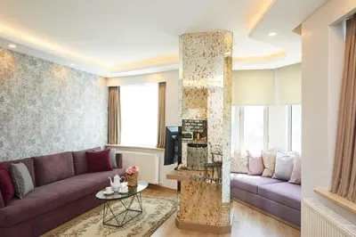 a living room with a purple couch and a table at All Seasons Suites in Istanbul