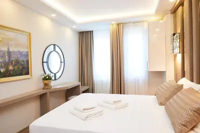 a hotel room with a white bed and a window at All Seasons Suites in Istanbul