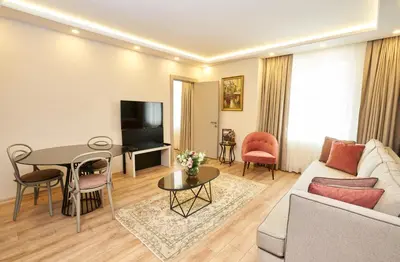 a living room with a couch and a table at All Seasons Suites in Istanbul