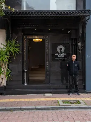 a man standing in front of a building at All Seasons Suites in Istanbul