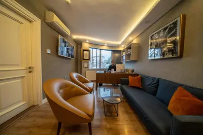 a living room with a blue couch and a table at All Seasons Suites in Istanbul