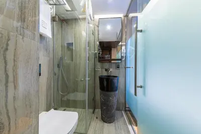 a bathroom with a toilet and a glass shower at Opale Hotel in Istanbul