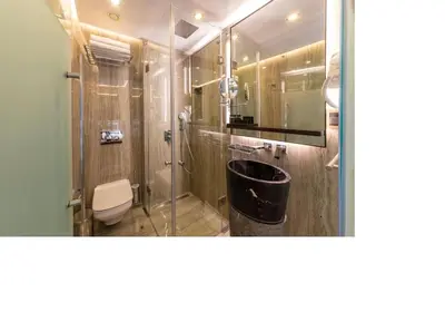 a bathroom with a shower with a toilet and a sink at Opale Hotel in Istanbul