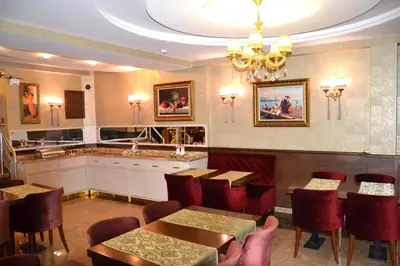 a restaurant with tables and chairs and a chandelier at Elysion Hotel in Istanbul