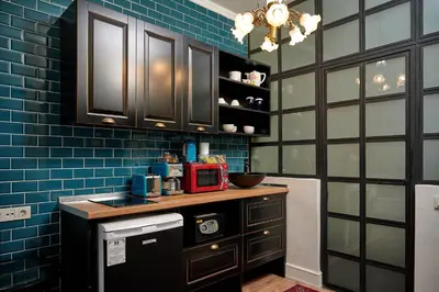 a kitchen with black cabinets and a red microwave at Faik Pasha Hotels Special Category Beyoglu Istanbul in Istanbul