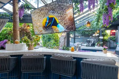 a restaurant with a bar with chairs and flowers at Malta Bosphorus Hotel in Istanbul