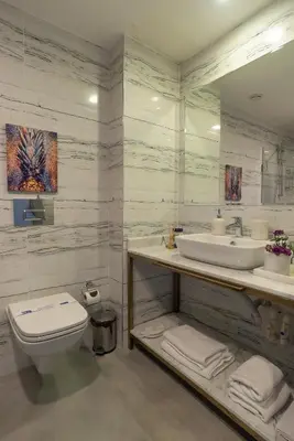 a white bathroom with a sink and a toilet at Malta Bosphorus Hotel in Istanbul