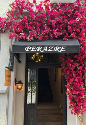 a entrance to a restaurant with pink flowers over the door at Perazre Hotel in Istanbul
