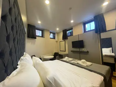 a hotel room with a bed and a television at Spinel Hotel - Old City in Istanbul