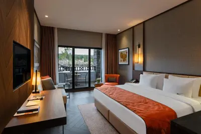 a hotel room with a large bed and a balcony at Elite World Grand Sapanca in Sapanca