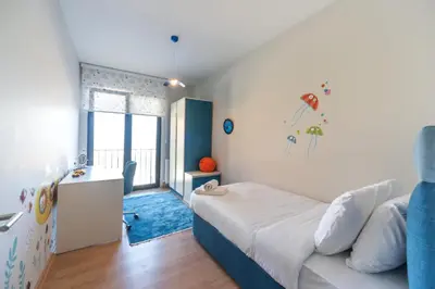 a small bedroom with a bed and a desk at Green Hills Suites in Yalova