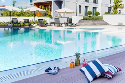 a swimming pool with a pair of flip flops and a pair at Green Hills Suites in Yalova