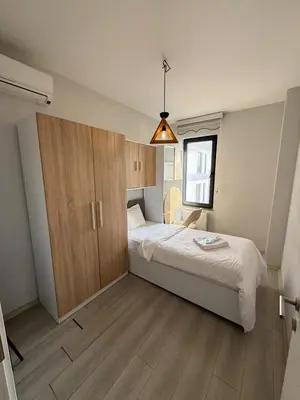 a small bedroom with a bed and a cupboard at Green Hills Suites in Yalova