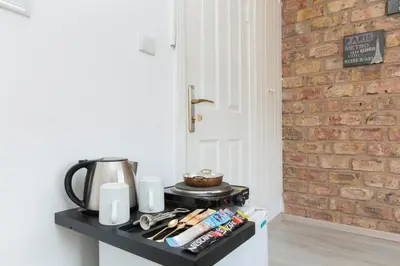 a kitchen counter with a coffee pot and a brick wall at Antique Boutique in Istanbul