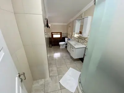 a bathroom with a toilet and a sink and a mirror at Doğa Villa Guest House in Buyukcekmece