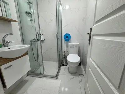 a bathroom with a shower and a toilet and a sink at Doğa Villa Guest House in Buyukcekmece