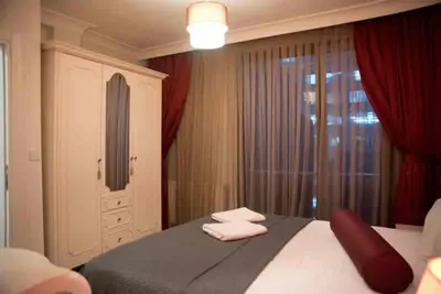 a bedroom with a bed with two towels on it at Nupelda Residence Hotel in Istanbul