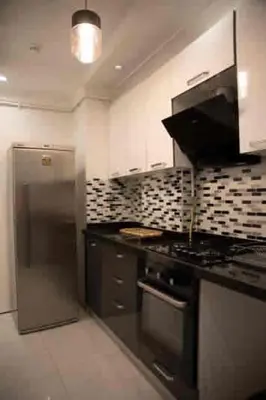 a kitchen with a stove and a refrigerator at Nupelda Residence Hotel in Istanbul