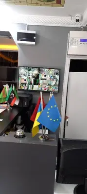 an office cubicle with a desk with flags on it at Grand FM Hotel in Istanbul