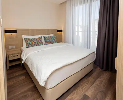 a bed in a room with a large window at Princess Residence in Istanbul