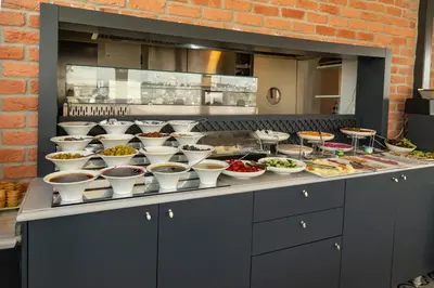 a buffet line with bowls of food in a kitchen at Meroddi La Porta in Istanbul