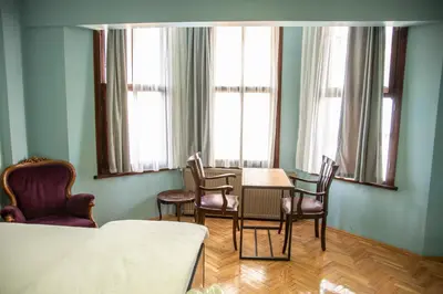 a dining room with a table and chairs and windows at YOLO Hostel in Istanbul