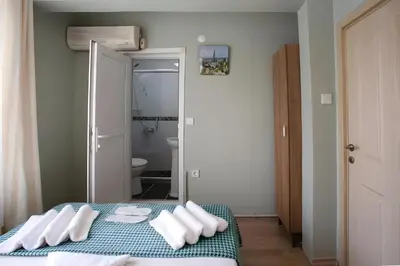 a bedroom with a bed with white pillows on it at Sofia Corner Hotel in Istanbul