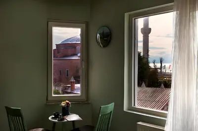a room with two windows and a table and a tower at Sofia Corner Hotel in Istanbul